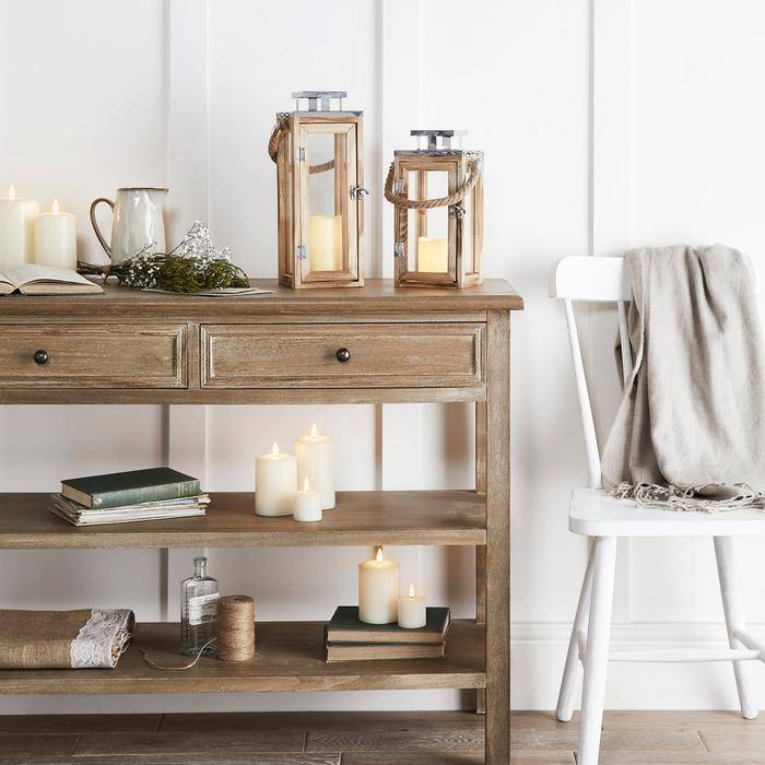 Lanterns and candles displayed on wooden table