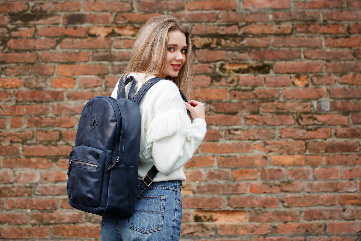 girl with navy leather backpack