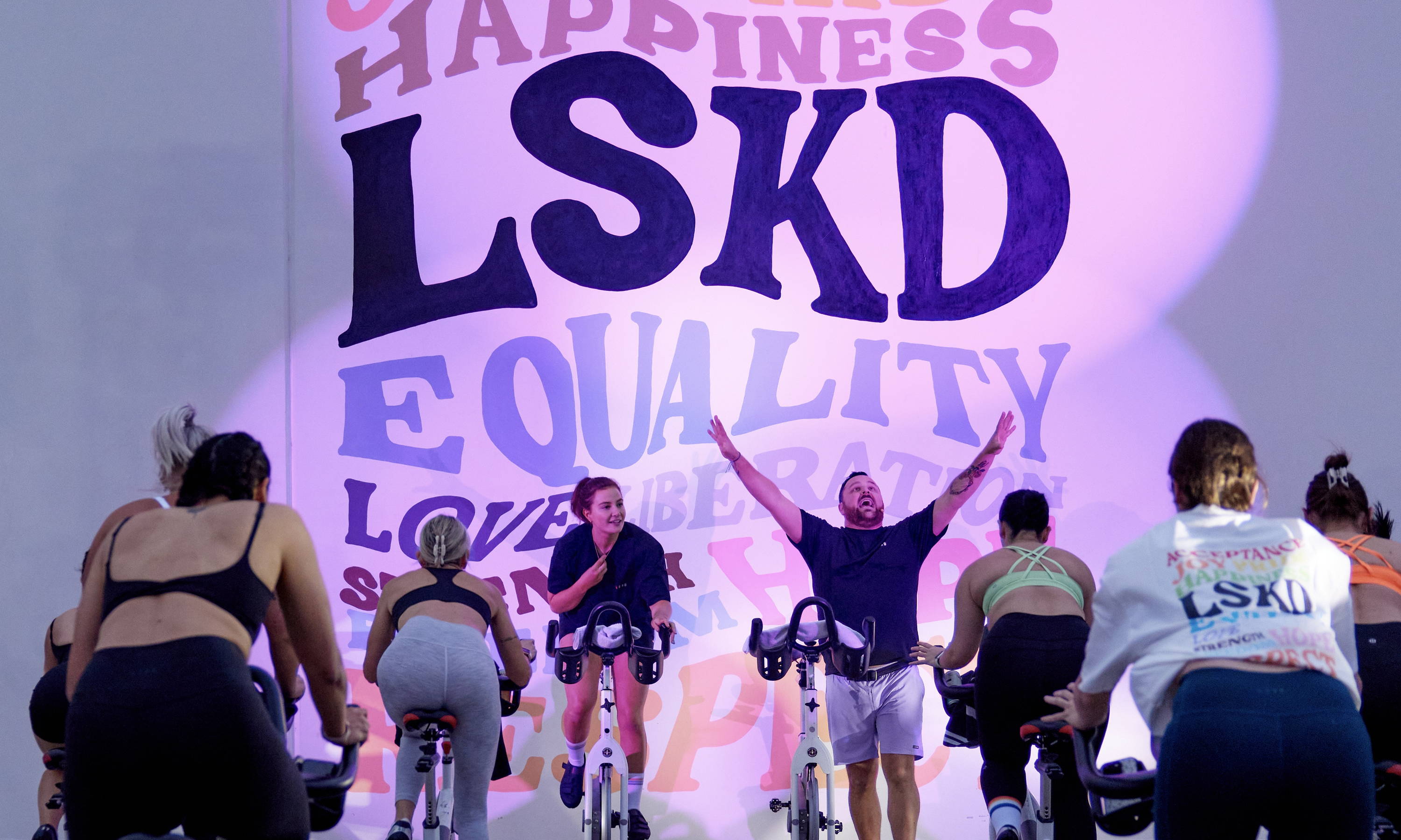 people celebrating pride month 2023 doing a cycle class on the gold coast