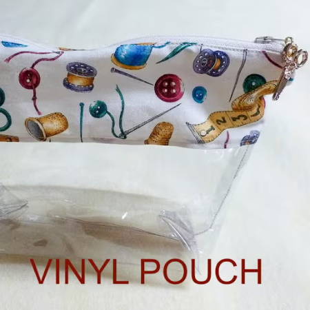 A clear vinyl pouch sewn with a zipper and a fabric layer on the top