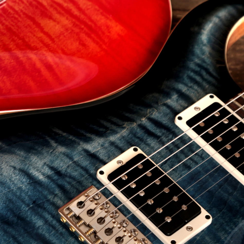Close-up of a PRS Custom 24 electric guitar in dark blue.