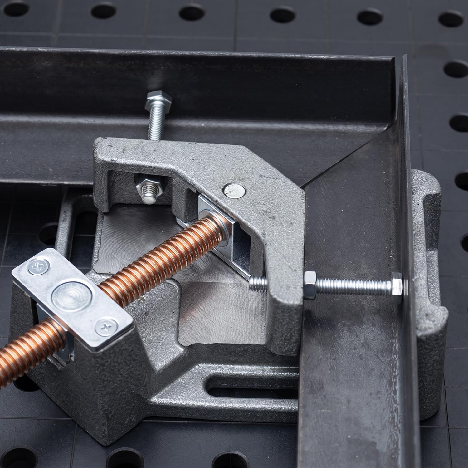 Close-up of a clamp mechanism on a workbench.
