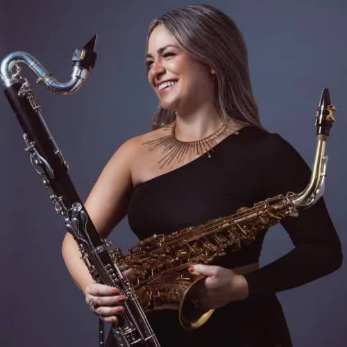 Emily Pecoraro holding bass clarinet and alto saxophone