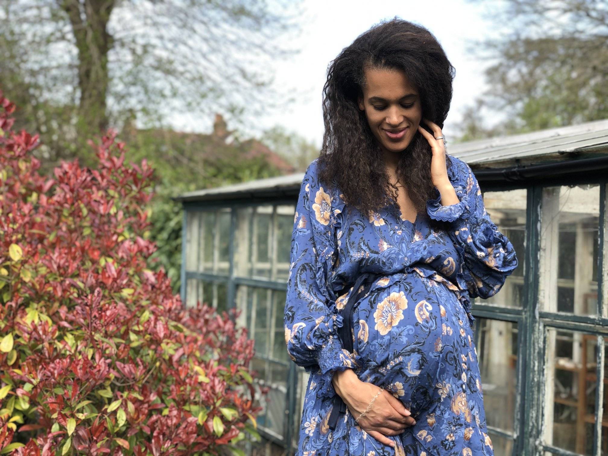 Shakira Akabusi In Blue Floral Dress Holding Baby Bump