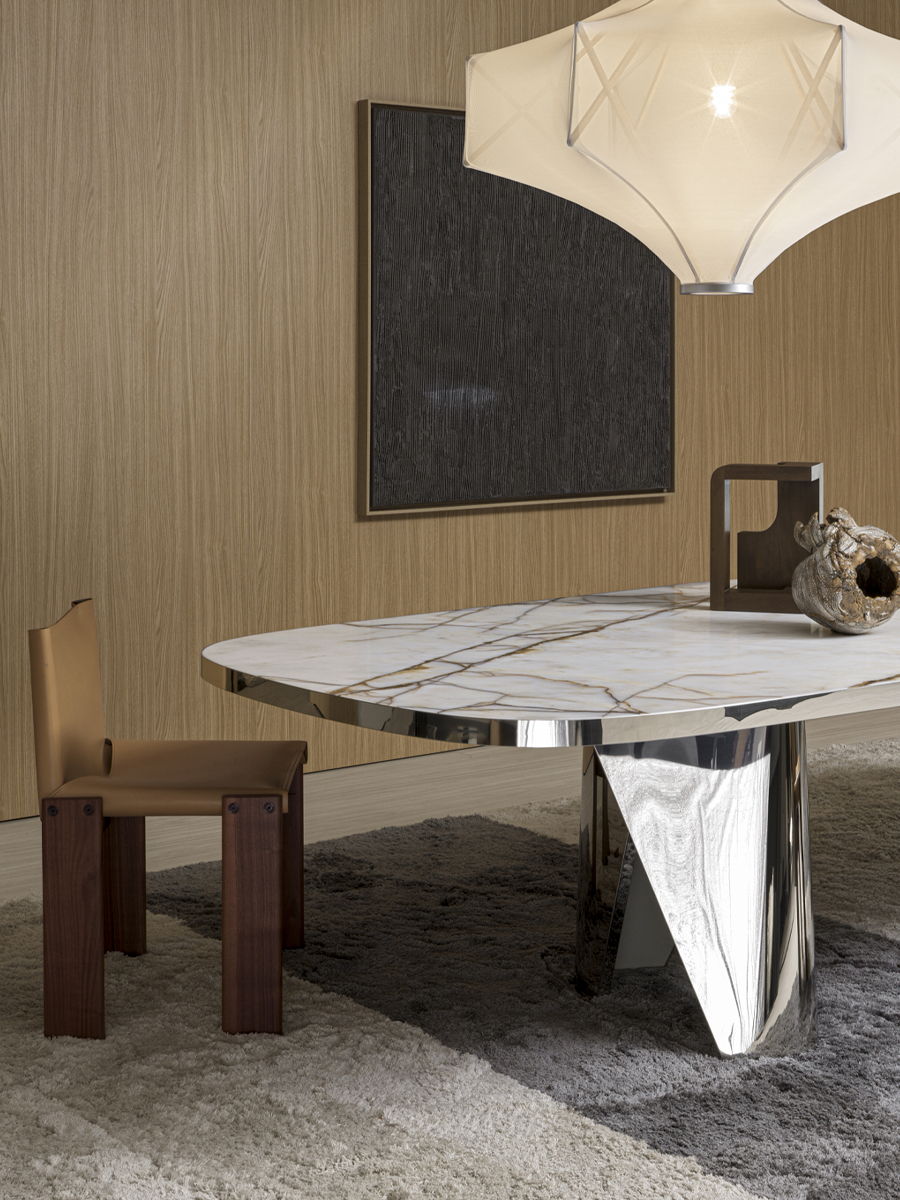 Modern dining room with a marble table, wooden chair, and unique lighting.