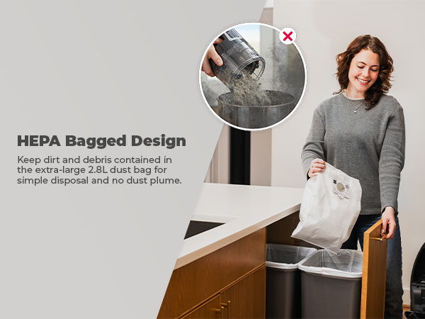 Woman disposing of a HEPA bag in a trash can by a kitchen counter.