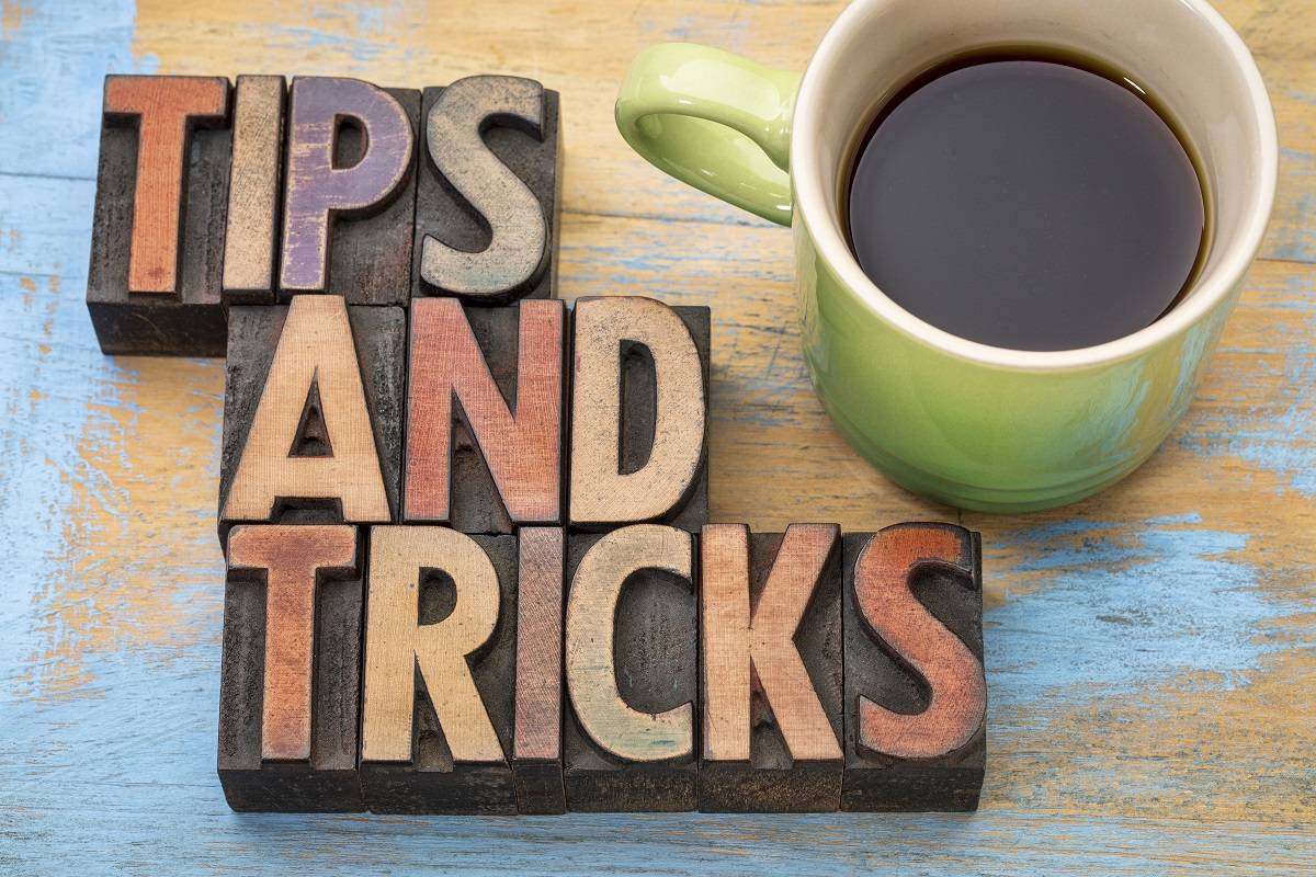 Letter blocks that spell out Tips and Tricks with coffee on the side