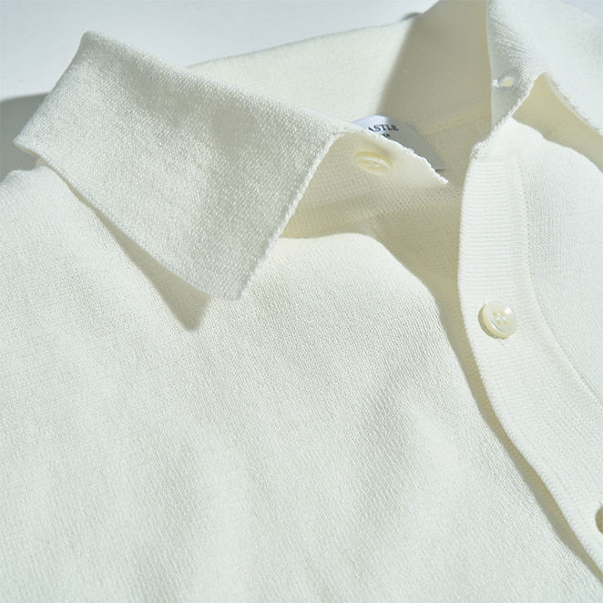 Close-up of a white polo shirt with a collar and buttons.