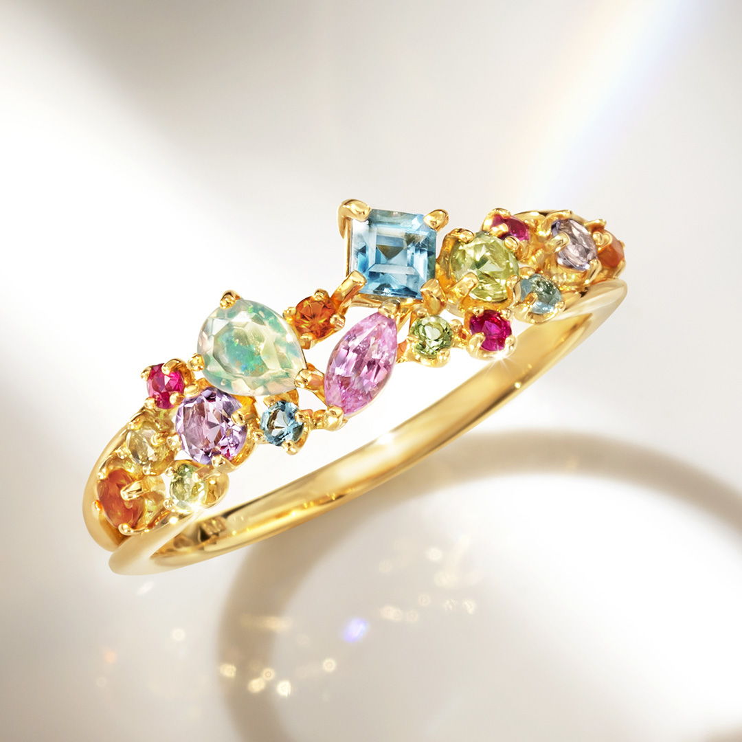 Colorful gemstone bracelet on a reflective surface.
