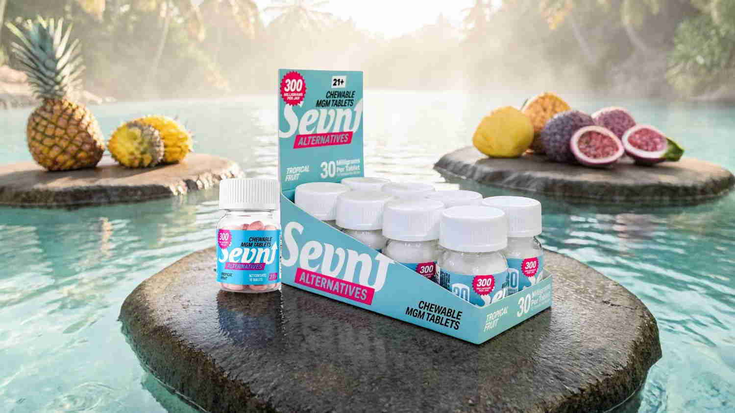 Bottles of skincare products on a rock near tropical fruits by water.