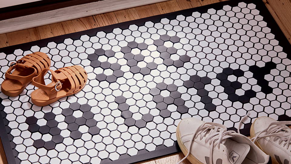 letterfolk tile mat at entryway with shoes