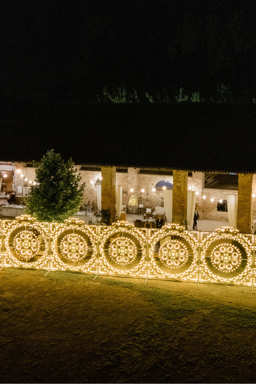 Decorative lights illuminate a venue at night, creating a festive atmosphere.