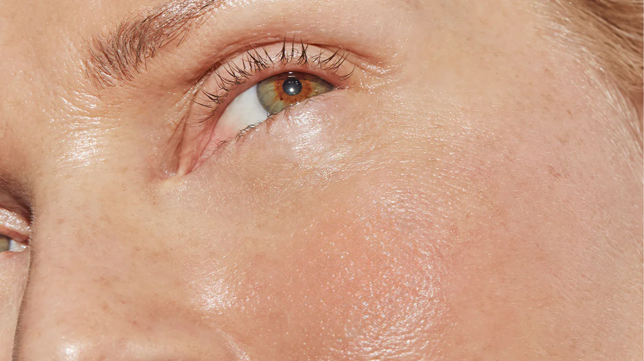 Close-up of a person's face focusing on the eye and skin texture.