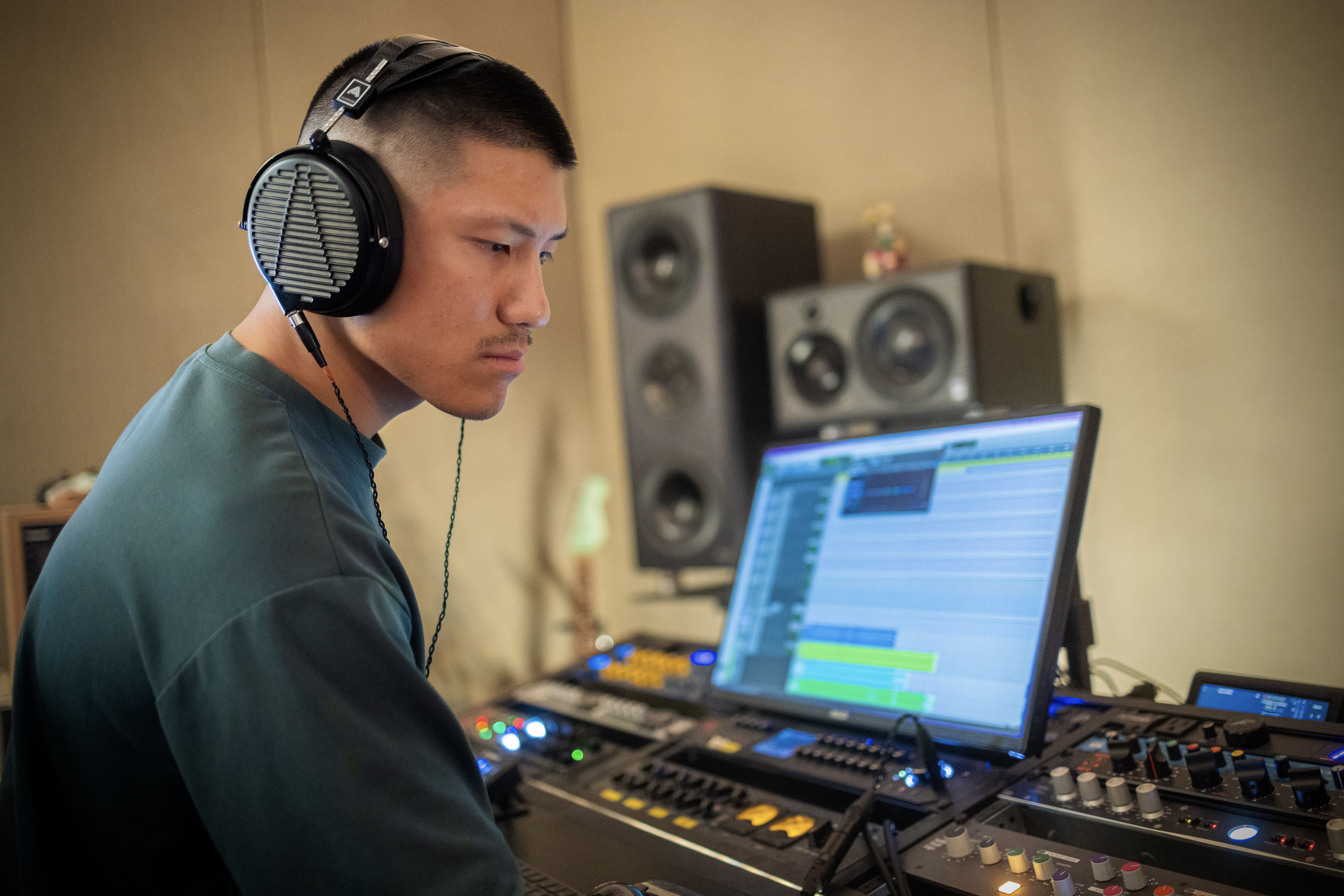 Andrew Kim wearing Audeze LCD-MX4 headphones in the studio 