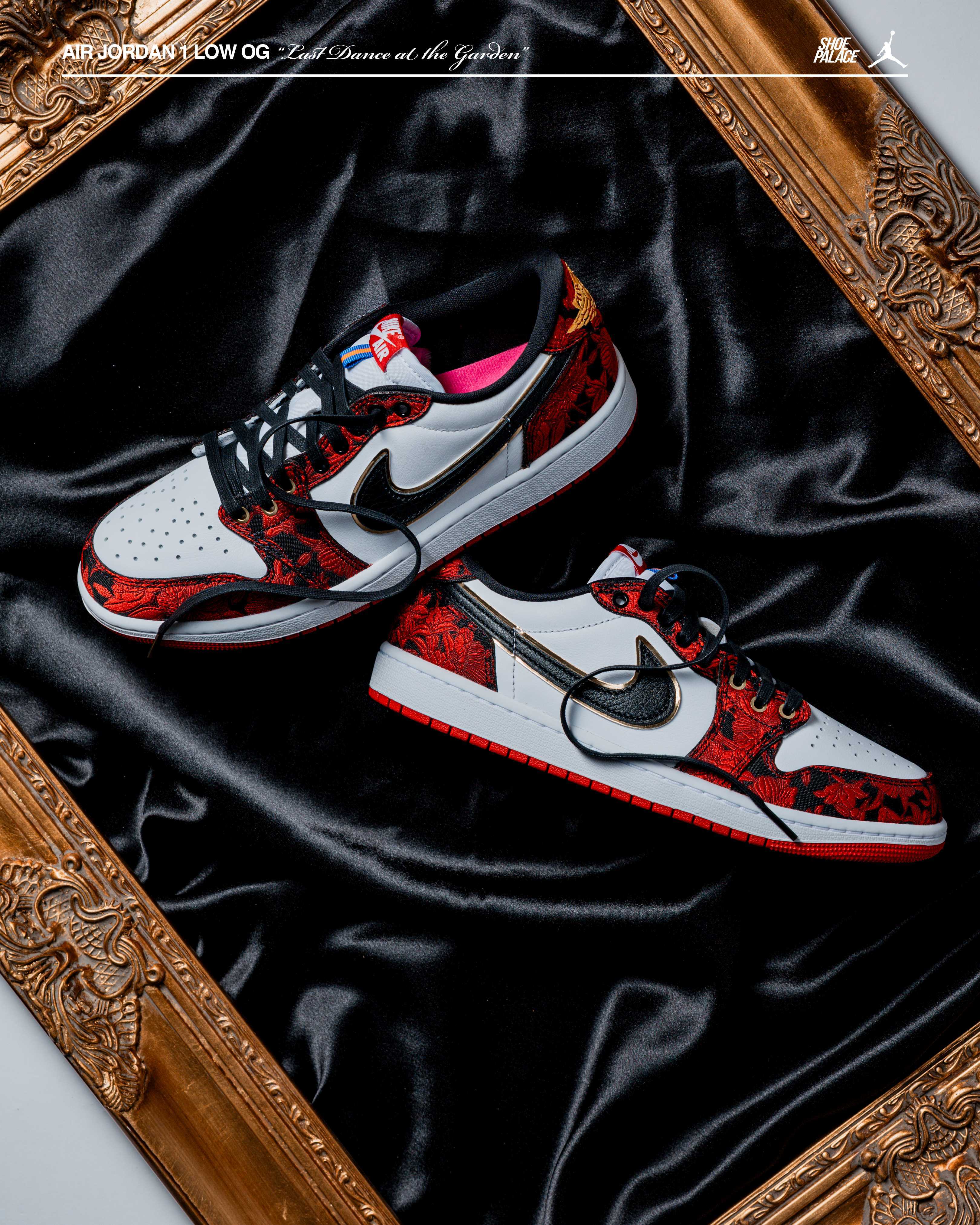 Nike sneakers displayed on a black satin surface within a decorative frame.