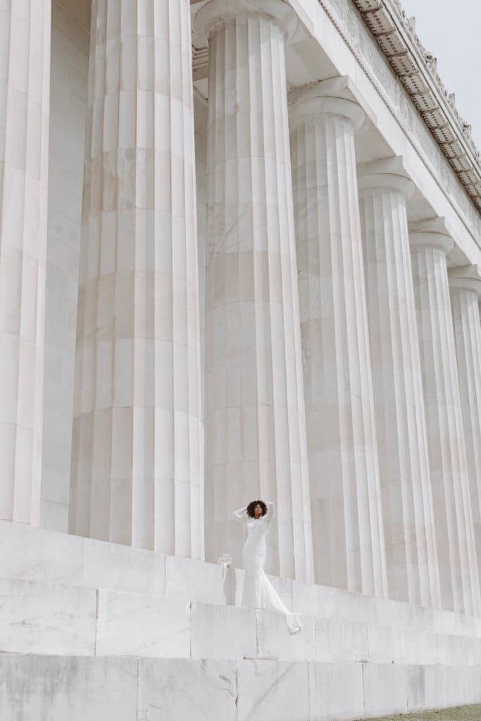 Bride out front of white and grey sandstone building in Washington DC