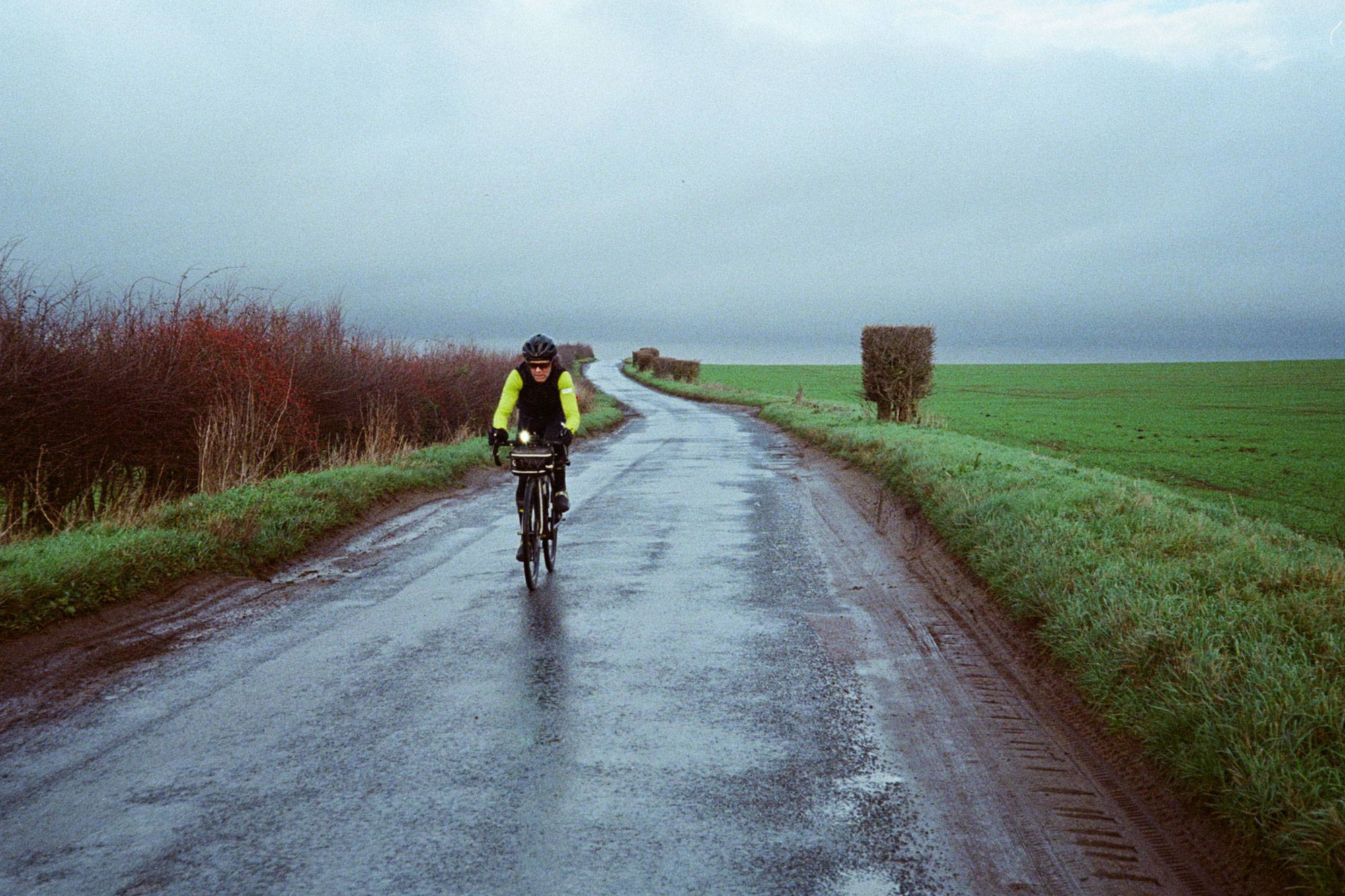 Cyclist in winter, country lane