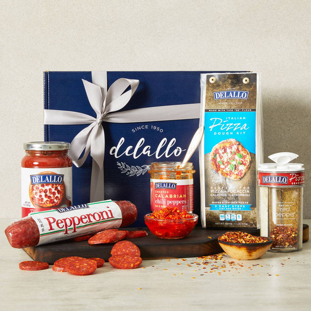 Assorted DeLallo pizza ingredients arranged in front of a gift box