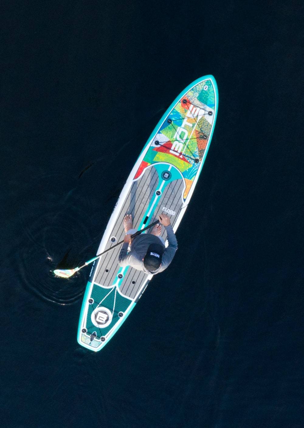 Overhead view of a man paddling his Flood Gatorshell Native Patchwork
