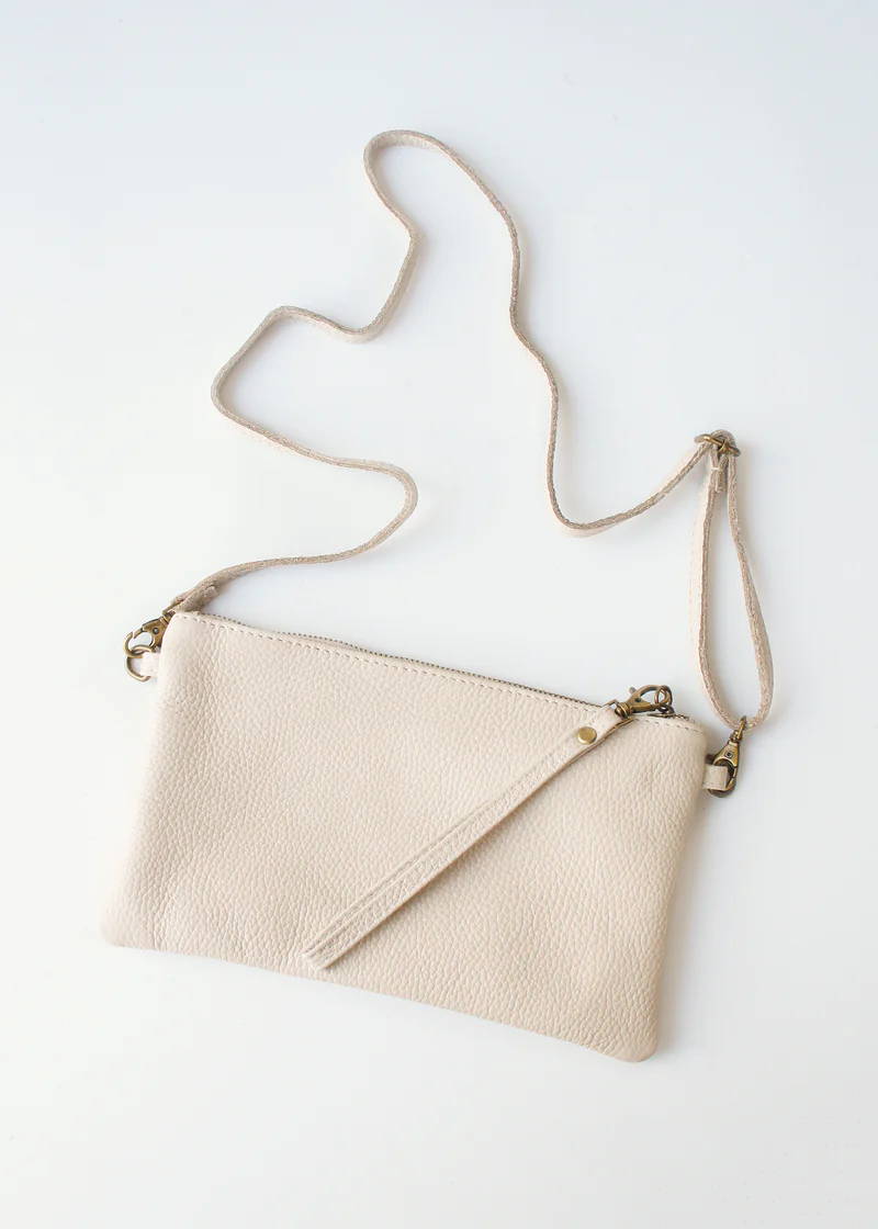 A off white leather purse with matching strape and zip handle