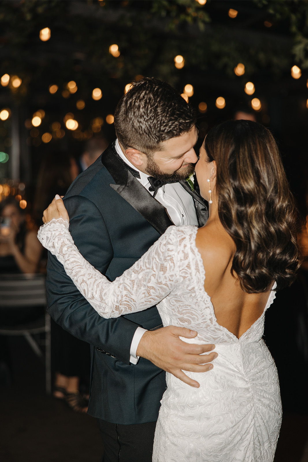 Couple dancing closely, sharing a romantic moment at a wedding reception.
