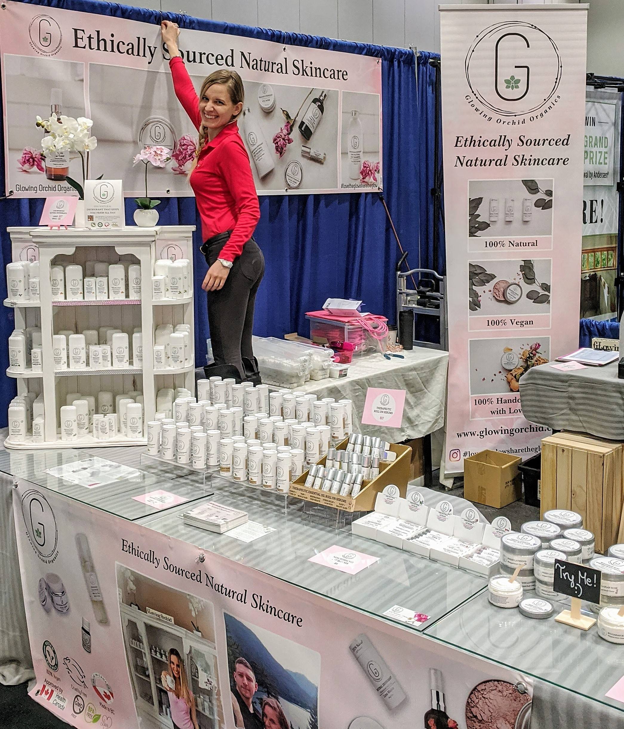 Judit hanging banner at the 2020 Wellness trade show