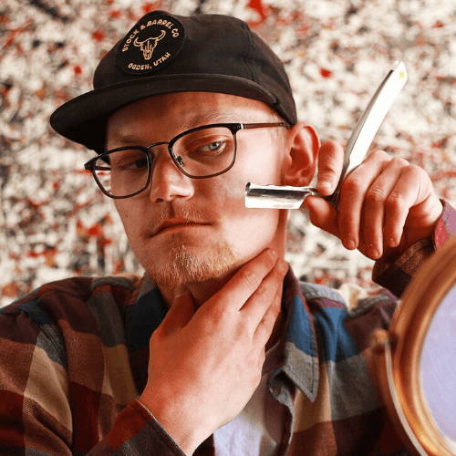 Guy with Glasses and Cap Holding Merlin Straight Razor