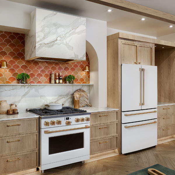 Modern kitchen with wooden cabinets, marble countertop, and stainless steel appliances.