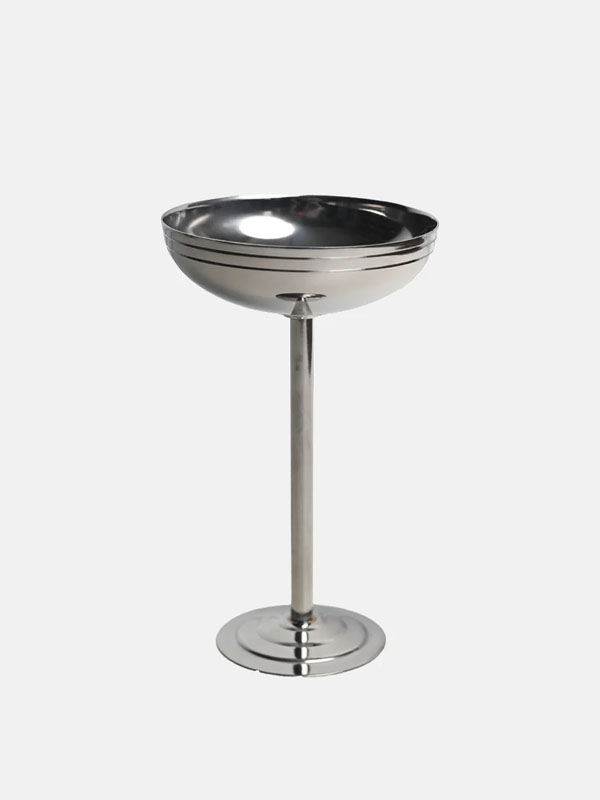 A shiny metal pedestal bowl on a stand.