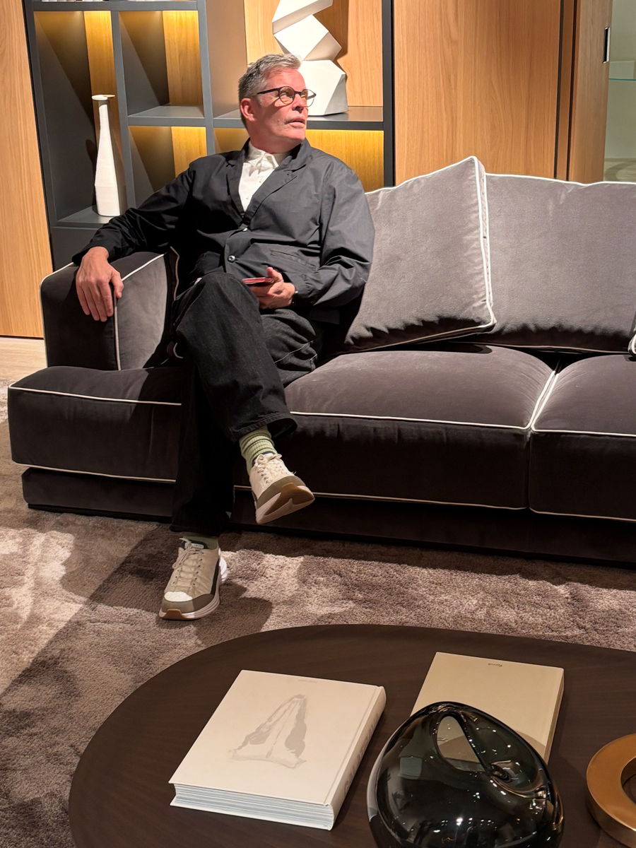 A person sitting on a sofa in a stylish interior setting.