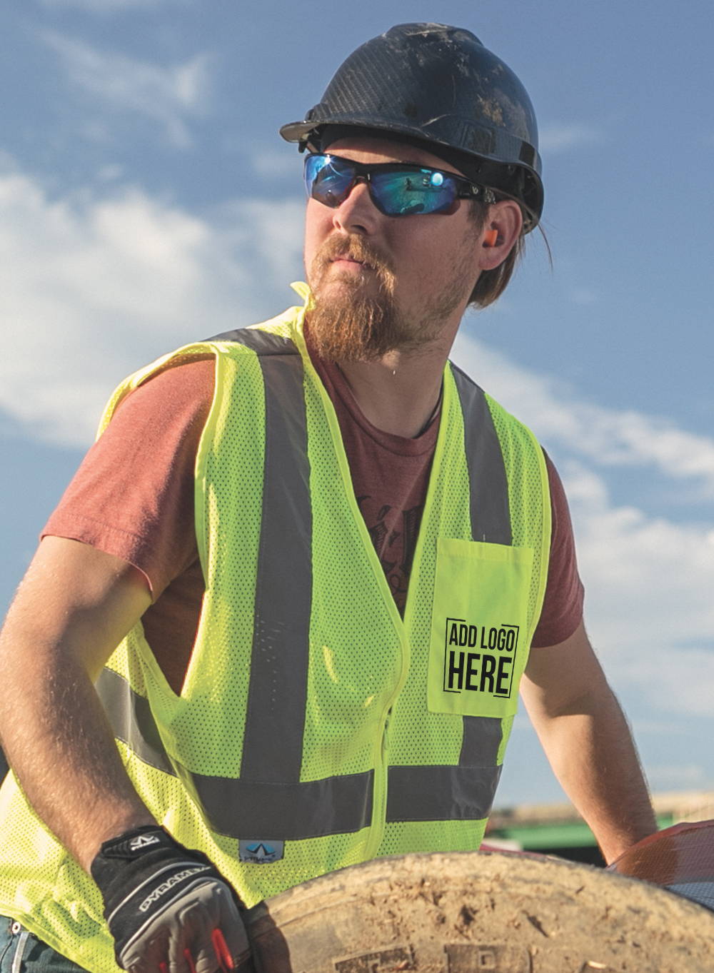 Construction worker wearing hard hat, safety glasses and hi-vis vest with company logo custom printed on pocket.