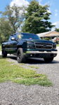 Front three-quarter Lukas' dark green 2006 Chevy Silverado extended cab on gravel photo 1