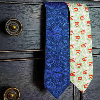 Two novelty ties hanging from dresser drawer