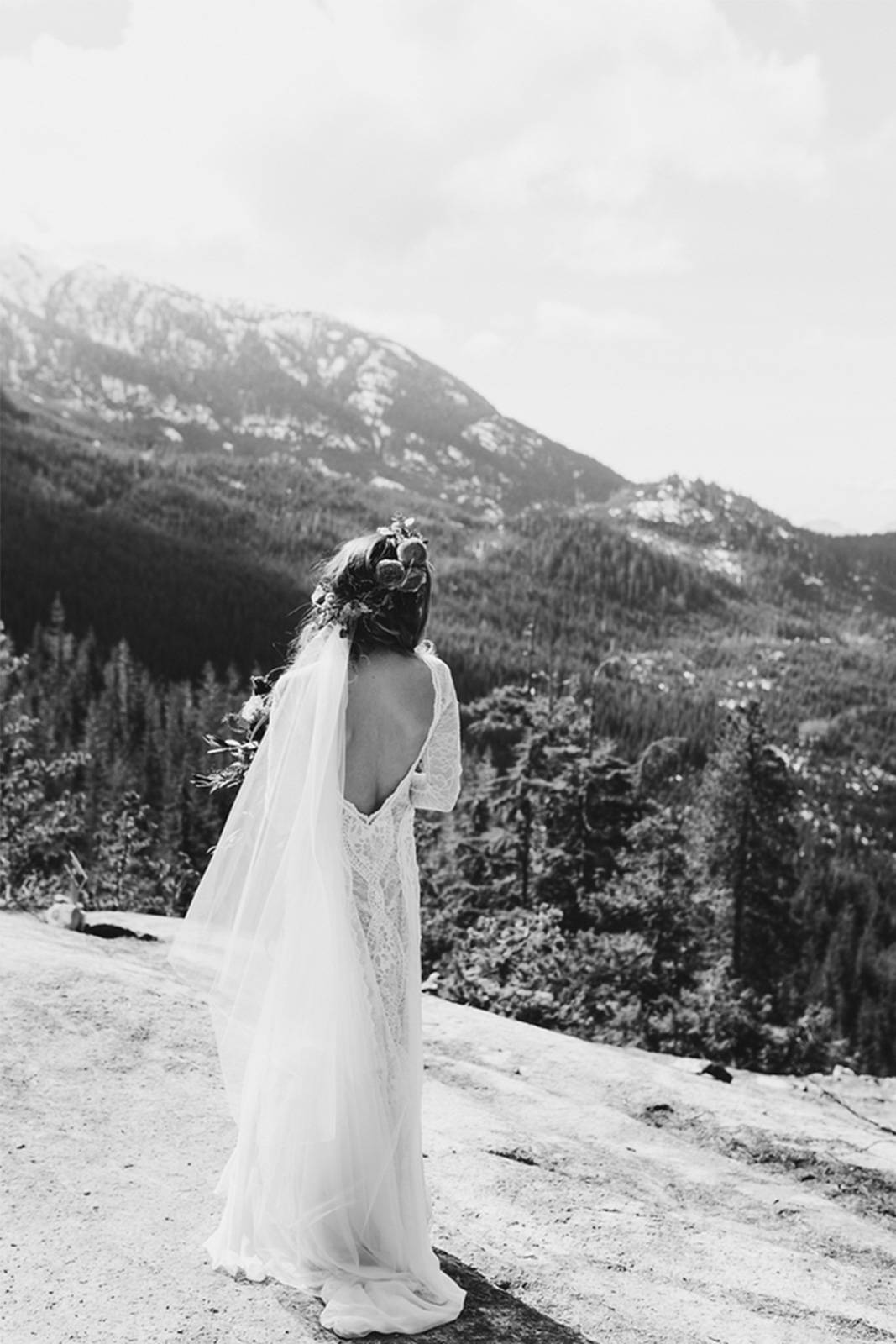 Black and white photo of women with lace wedding dress