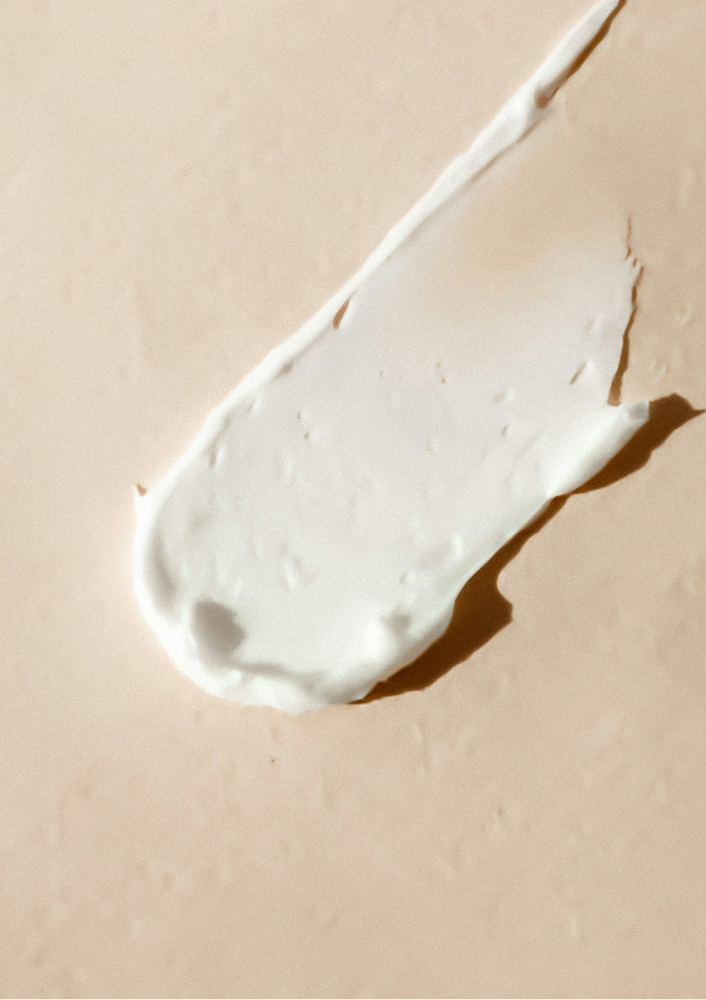 A smear of makeup cream on an adobe surface