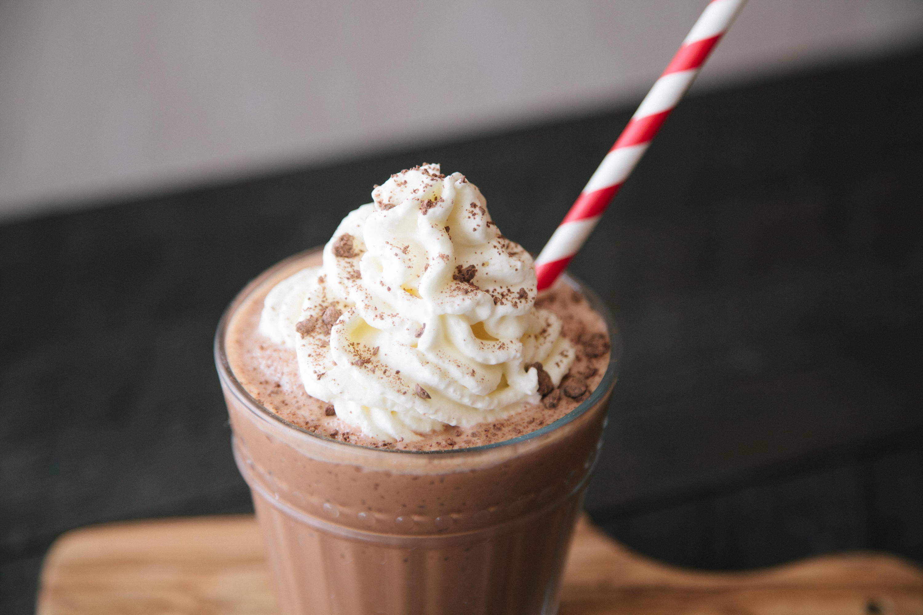 Fun drinking chocolate with whipped cream and striped straw