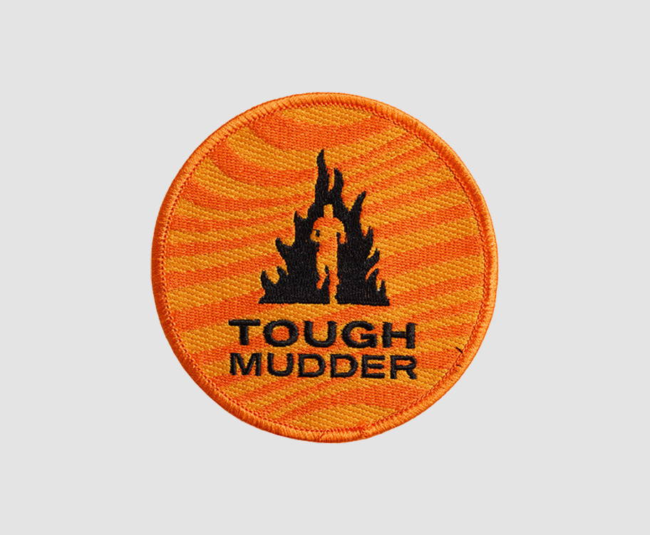A product image of an orange Tough Mudder circle patch