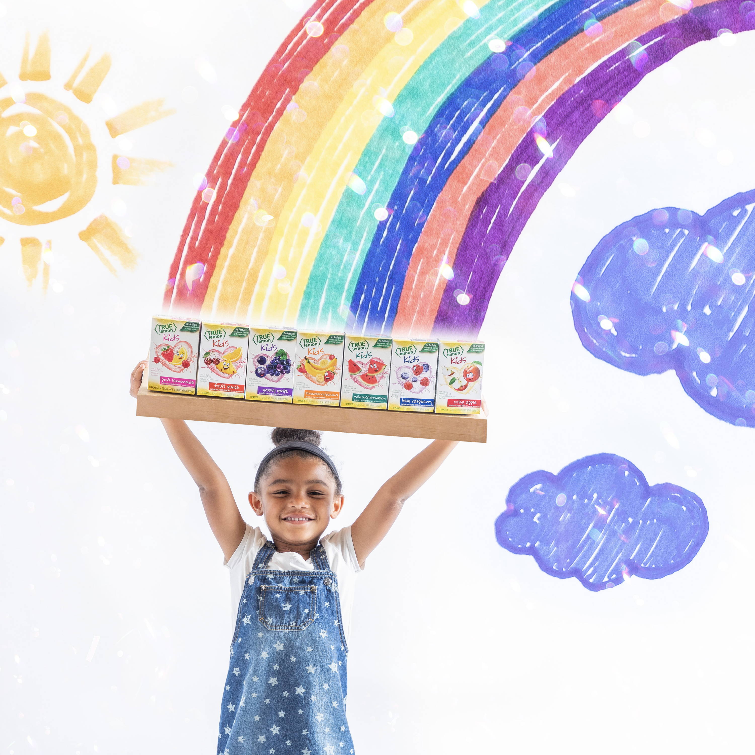 At the end of a rainbow a girl in blue jumper holds up 7 boxes of different flavored true lemon drink mixes