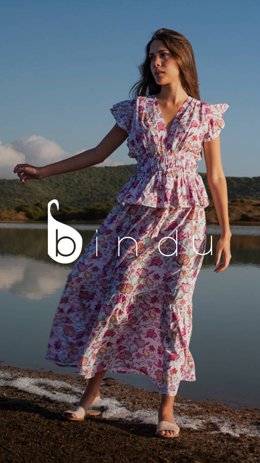 Young woman standing on bFabric with floral dress and sandals