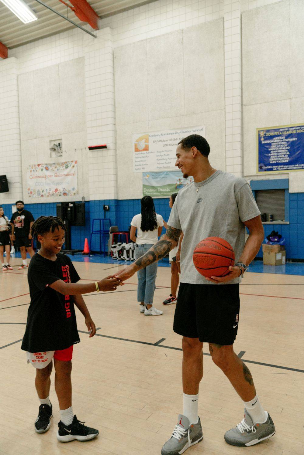 juan toscano giving a boy a handshake