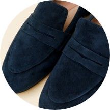 Dark blue suede loafers with a simple design.
