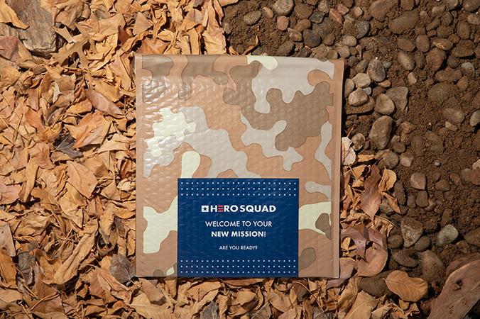 Camouflage-patterned bubble mailer on a bed of wood chips.