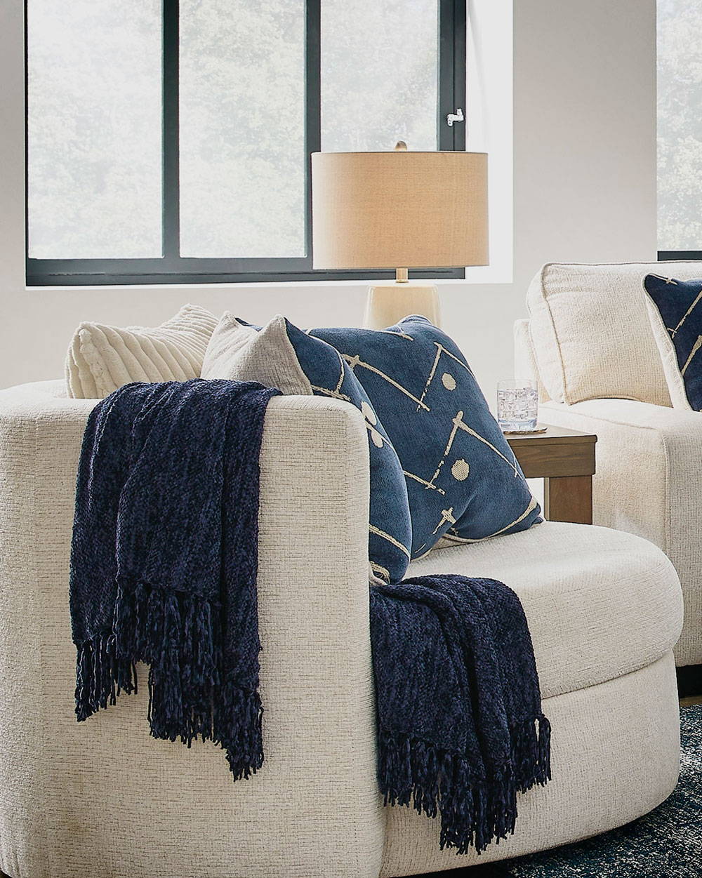 A Cozy Nook with blue throw pillows and a throw blanket