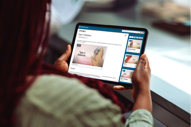 Person holding a tablet displaying ADAM content.