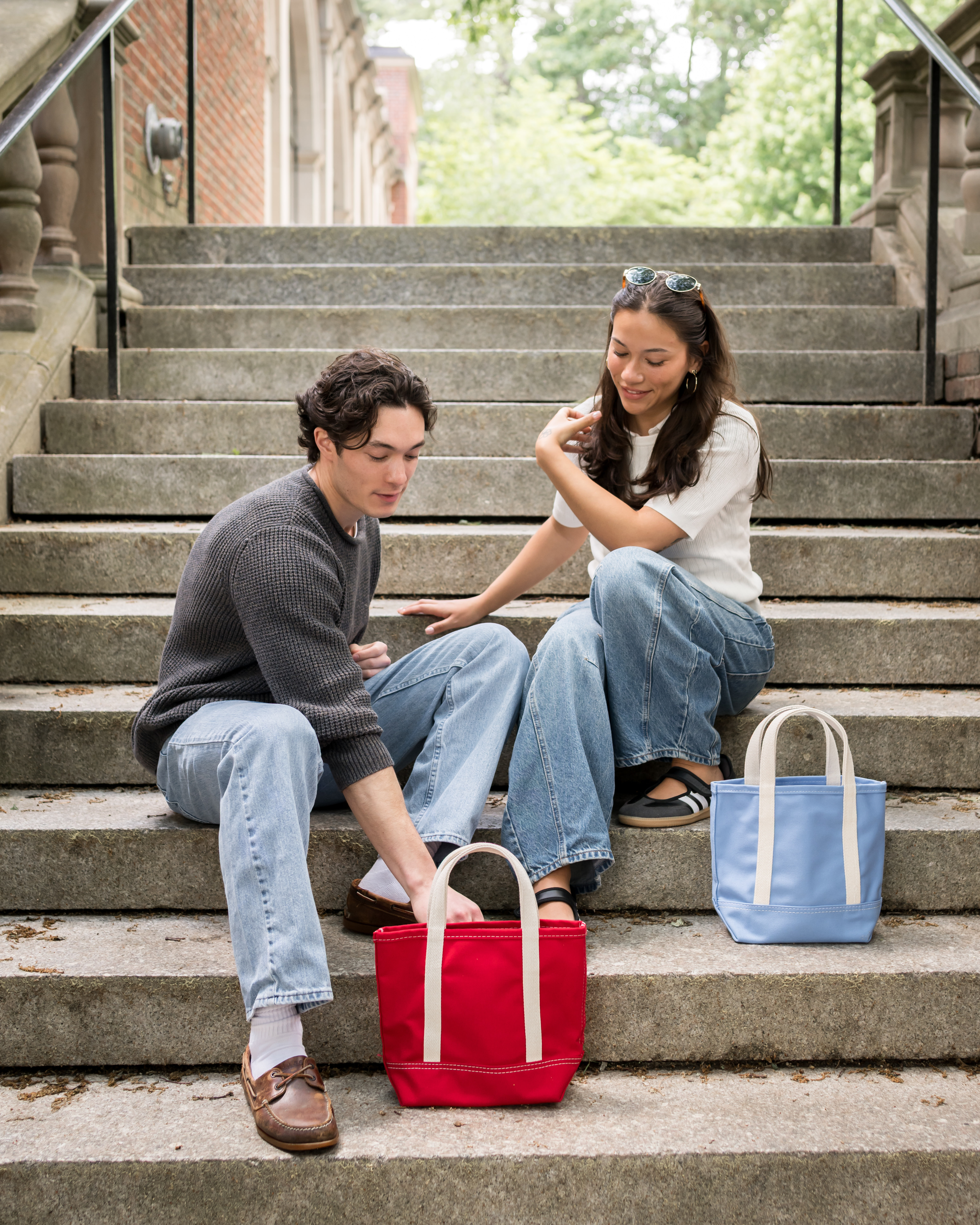 Students unpacking storage bins on dorm steps