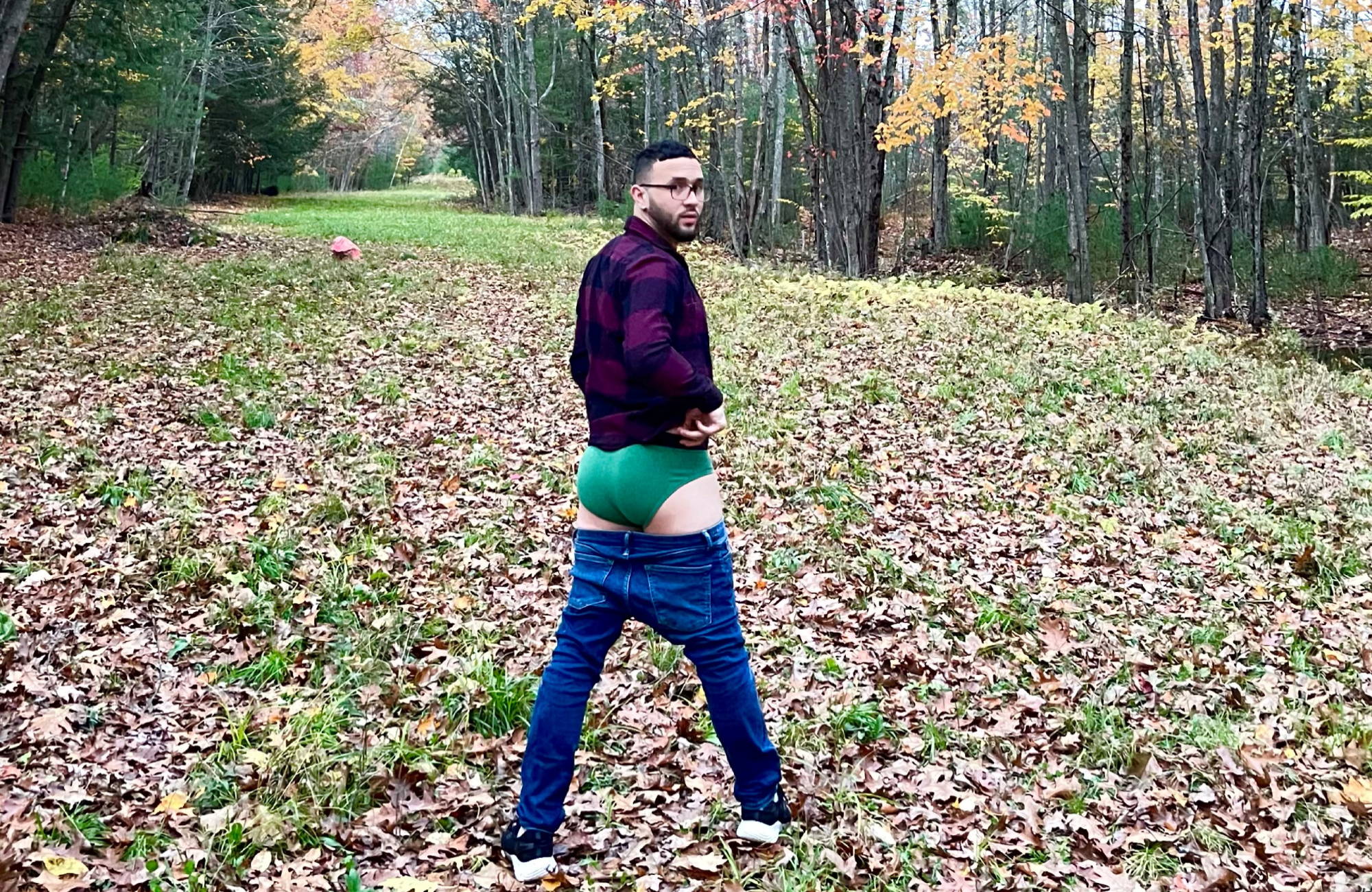 man in red flannel and jeans around his thighs to show off his green briefs 