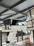 White motor yacht docked in covered slip with flybridge and marine antennas photo 4