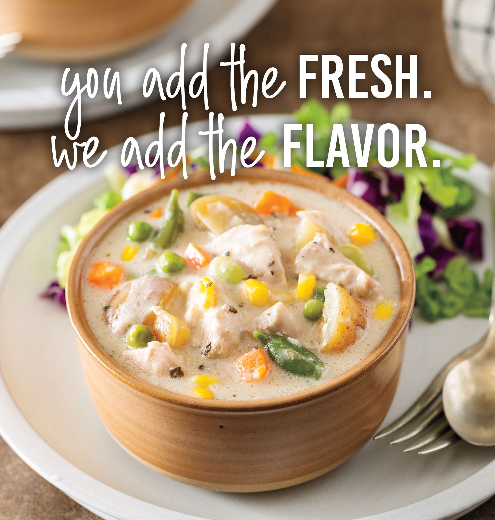 You add the fresh. We add the flavor. Bowl of creamy chicken and vegetable soup served with a side salad.
