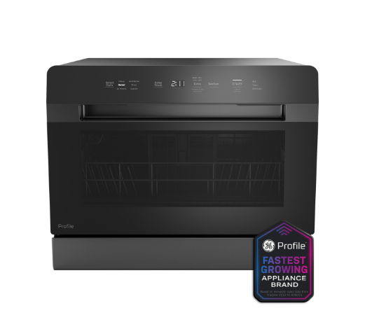 Black microwave oven with control panel and award badge.