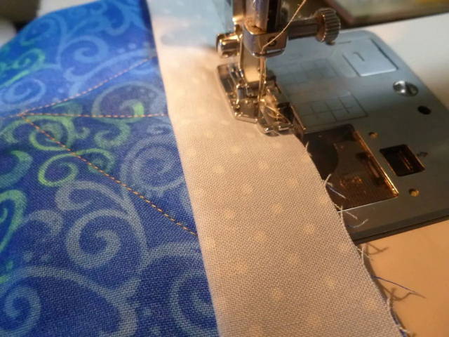 1/4 inch quilting foot with guide attaching a quilt binding strip